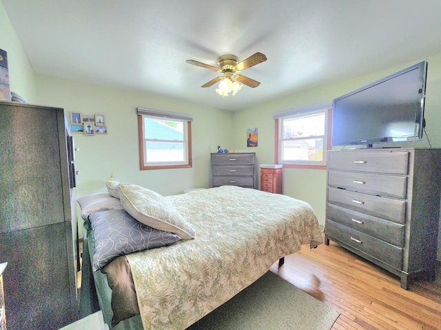 1239 Columbus Ave, Sheboygan, WI 53083 - bedroom featuring light wood-style flooring, multiple windows, and ceiling fan