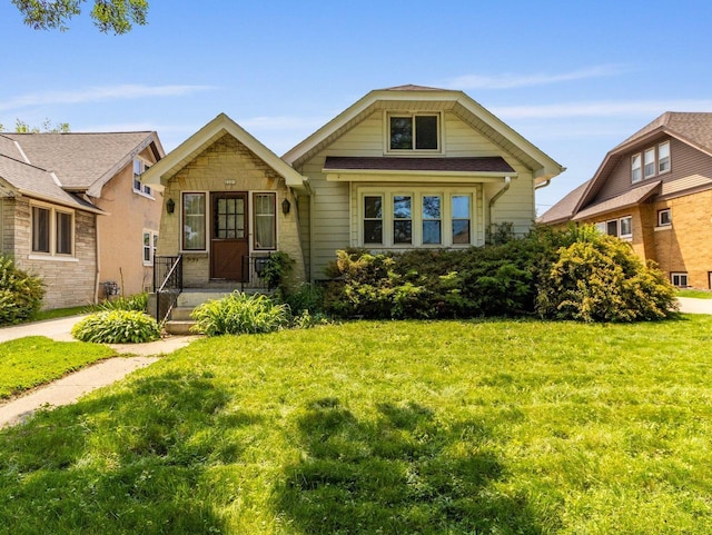 2221 N 60th St, Milwaukee, WI 53208 - bungalow-style home with a front lawn and stone siding