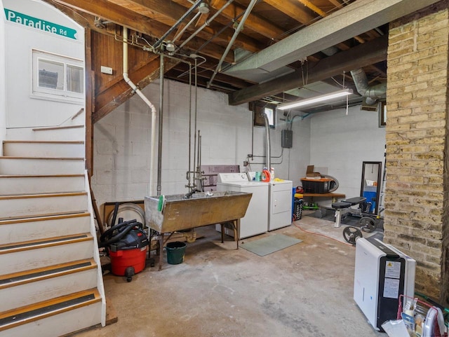 2221 N 60th St, Milwaukee, WI 53208 - unfinished basement with washing machine and clothes dryer, stairway, and concrete block wall