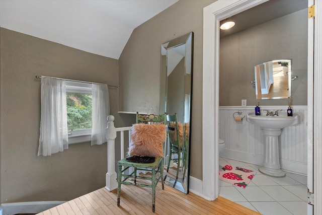128 Maple Ave, Hartland, WI 53029 - half bath featuring vaulted ceiling and wood finished floors