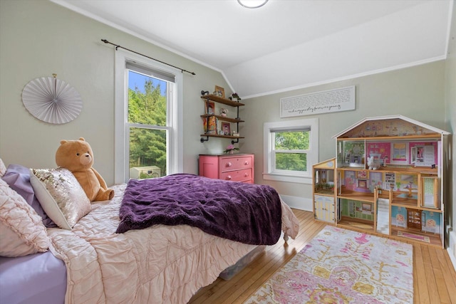 128 Maple Ave, Hartland, WI 53029 - bedroom featuring ornamental molding, vaulted ceiling, and hardwood / wood-style flooring