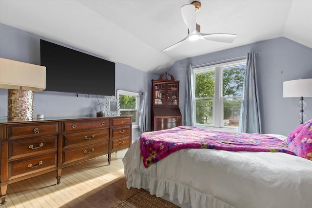 128 Maple Ave, Hartland, WI 53029 - bedroom with vaulted ceiling, light wood-style flooring, and ceiling fan