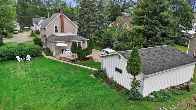 128 Maple Ave, Hartland, WI 53029 - view of property exterior with a wooden deck, a lawn, a shingled roof, and a chimney