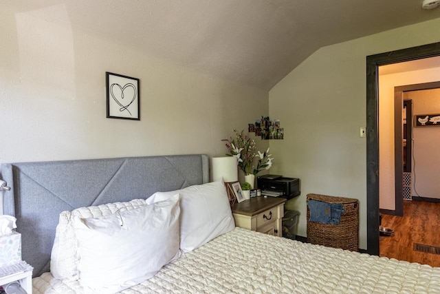 863 Jackson St, Oshkosh, WI 54901 - bedroom with lofted ceiling and wood finished floors
