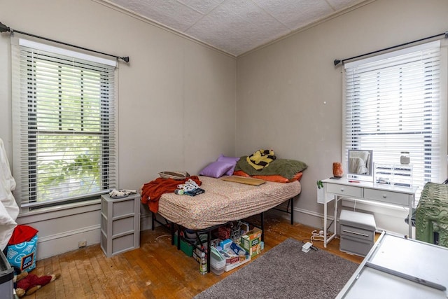 863 Jackson St, Oshkosh, WI 54901 - bedroom with wood-type flooring, multiple windows, crown molding, and an ornate ceiling
