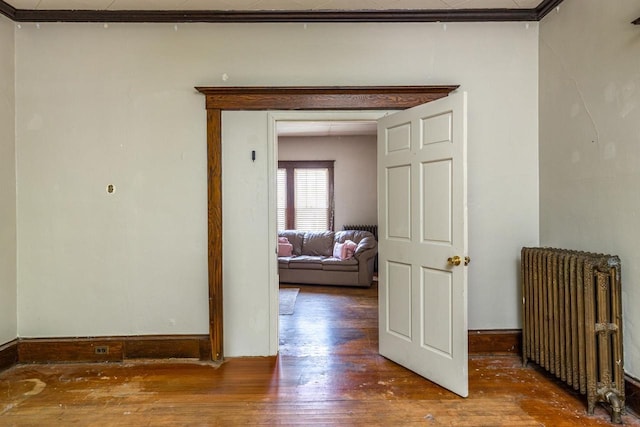 863 Jackson St, Oshkosh, WI 54901 - corridor with radiator heating unit and hardwood / wood-style floors