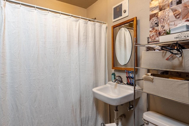 863 Jackson St, Oshkosh, WI 54901 - bathroom featuring toilet and a shower with shower curtain