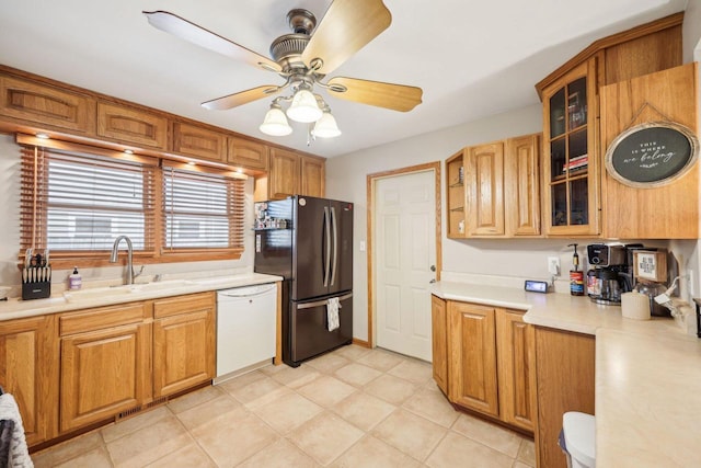 3901 Western Way, Racine, WI 53404 - kitchen with white dishwasher, freestanding refrigerator, light countertops, glass insert cabinets, and a ceiling fan
