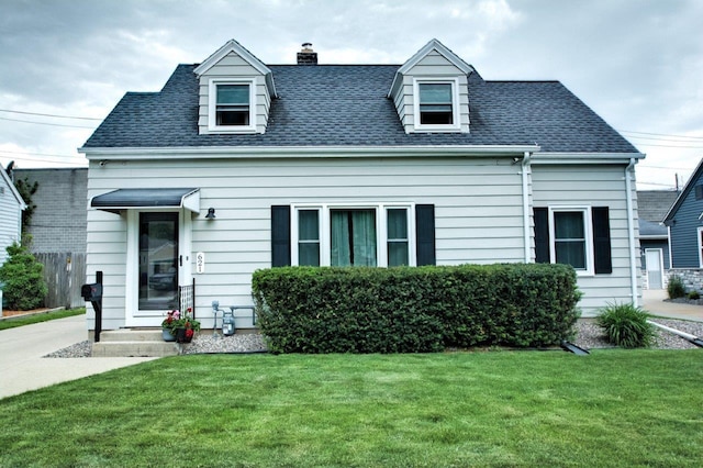 621 N Linwood Ave, Appleton, WI 54914 - cape cod home featuring a front lawn, a chimney, and a shingled roof