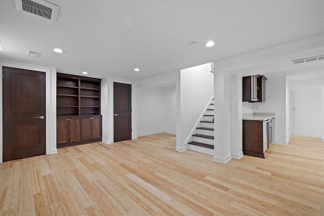 6834 S 35th St, Franklin, WI 53132 - below grade area with light wood finished floors, stairway, recessed lighting, and built in shelves