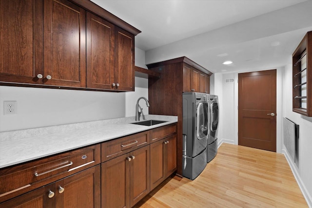 6834 S 35th St, Franklin, WI 53132 - washroom with washer and clothes dryer, cabinet space, light wood finished floors, and recessed lighting