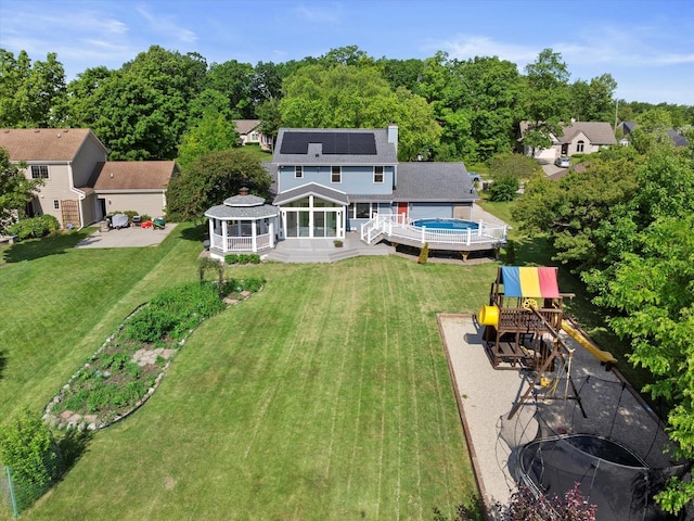 6834 S 35th St, Franklin, WI 53132 - back of house featuring a gazebo, a playground, solar panels, a shingled roof, and a yard