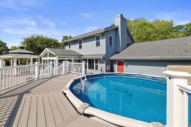 6834 S 35th St, Franklin, WI 53132 - outdoor pool with a deck, a gazebo, and a sunroom