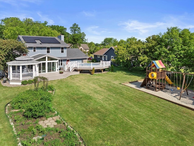 6834 S 35th St, Franklin, WI 53132 - view of grassy yard with a playground, a deck, and a sunroom