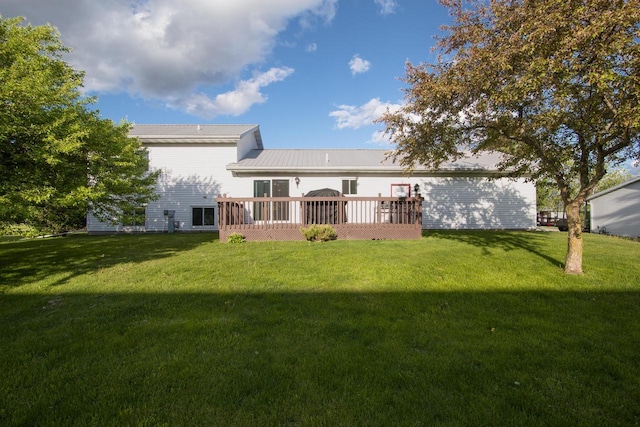 123 Westgate Dr, Iron Ridge, WI 53035 - rear view of property with a lawn, a deck, and a metal roof