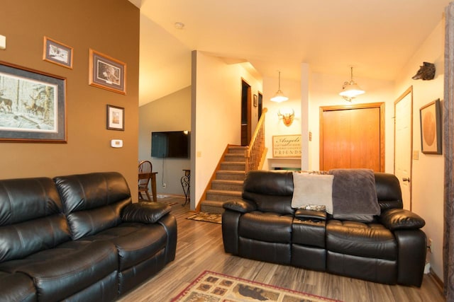 123 Westgate Dr, Iron Ridge, WI 53035 - living room with vaulted ceiling, wood finished floors, and stairs