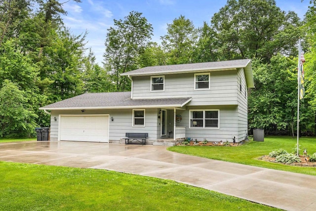 2311 Maplewood Dr, Plover, WI 54467 - traditional home with a garage, driveway, and a front yard