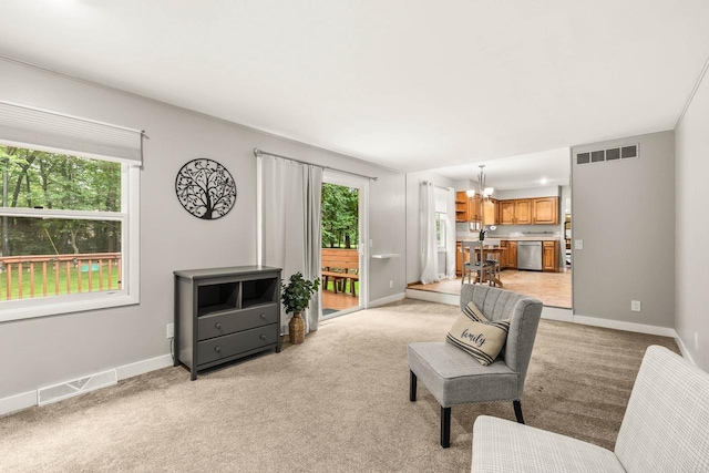 2311 Maplewood Dr, Plover, WI 54467 - living area featuring a chandelier and light carpet
