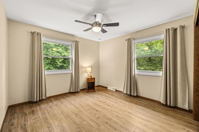 2311 Maplewood Dr, Plover, WI 54467 - spare room featuring healthy amount of natural light, light wood finished floors, and ceiling fan