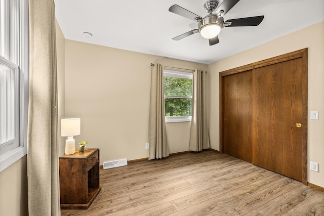 2311 Maplewood Dr, Plover, WI 54467 - bedroom featuring light wood-style flooring, ceiling fan, and a closet