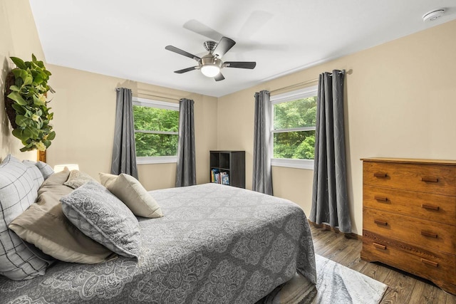 2311 Maplewood Dr, Plover, WI 54467 - bedroom featuring multiple windows, wood finished floors, and ceiling fan
