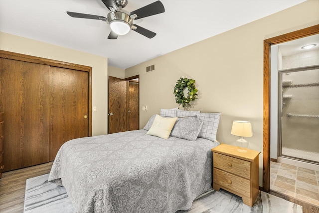 2311 Maplewood Dr, Plover, WI 54467 - bedroom with ceiling fan, a closet, and wood finished floors