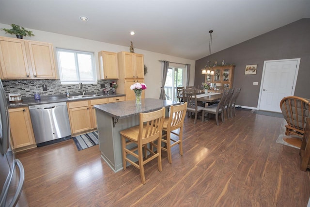708 Owl Ln, Stevens Point, WI 54482 - kitchen with dishwasher, light brown cabinets, dark countertops, vaulted ceiling, and dark wood-style floors