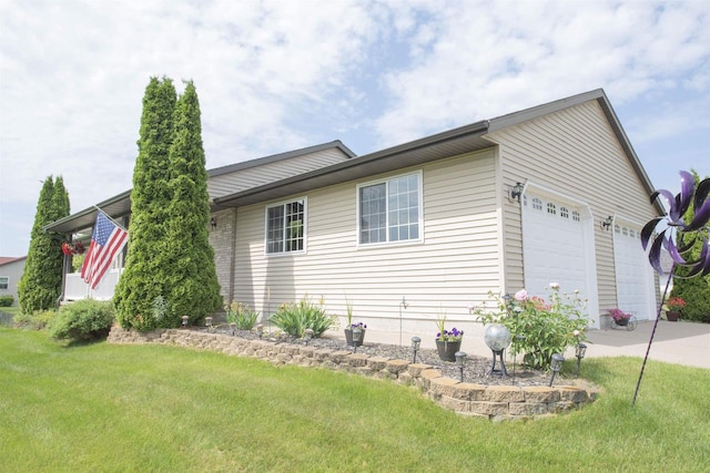 708 Owl Ln, Stevens Point, WI 54482 - view of side of property with a lawn, an attached garage, and concrete driveway