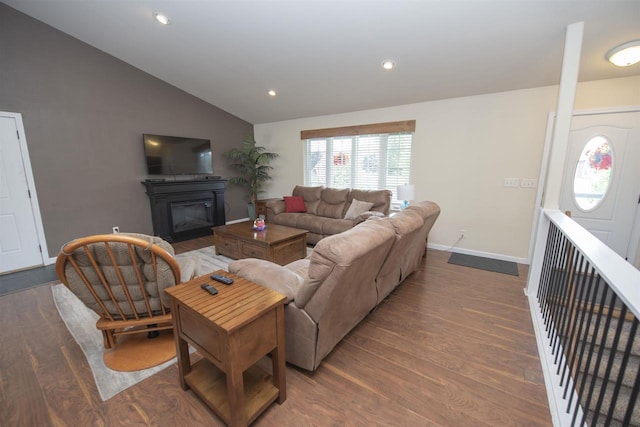 708 Owl Ln, Stevens Point, WI 54482 - living area with vaulted ceiling, wood finished floors, a glass covered fireplace, and recessed lighting