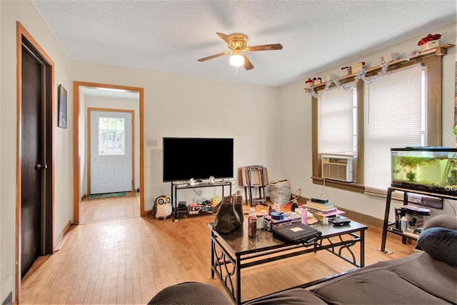 1208 Wisconsin St, Stevens Point, WI 54481 - living room with a ceiling fan, light wood-type flooring, a textured ceiling, and cooling unit