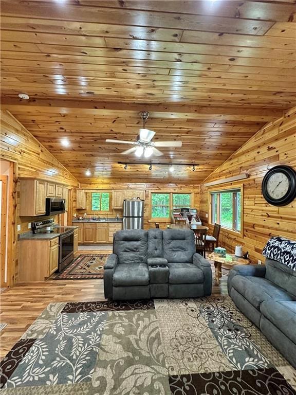 4686 W Butler Rd, Winter, WI 54896 - living room featuring wood walls, vaulted ceiling, light wood-style flooring, wooden ceiling, and ceiling fan
