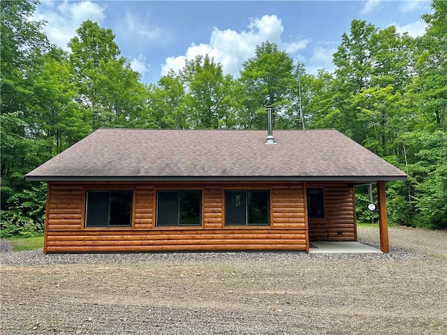 4686 W Butler Rd, Winter, WI 54896 - rear view of house with roof with shingles and log veneer siding