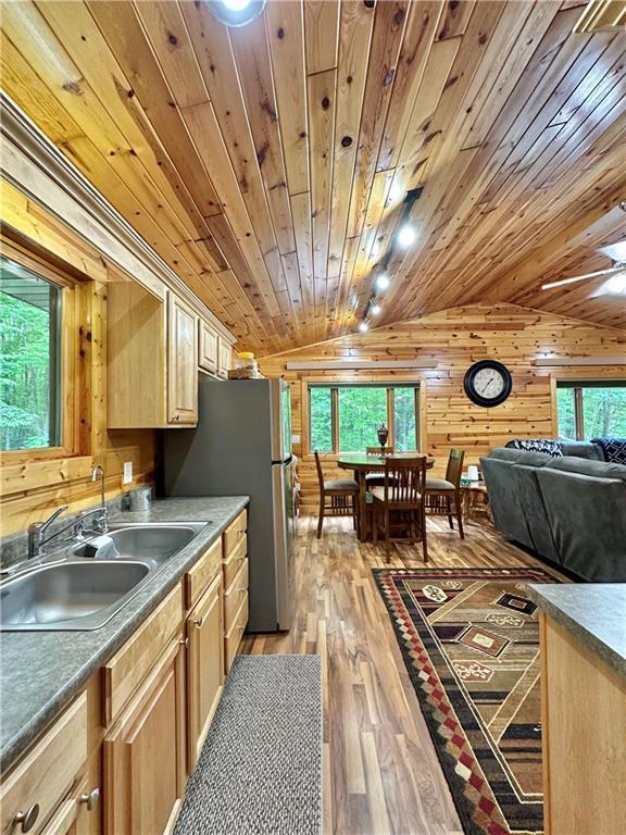 4686 W Butler Rd, Winter, WI 54896 - kitchen with light brown cabinets, wooden walls, plenty of natural light, light wood-style floors, and wooden ceiling