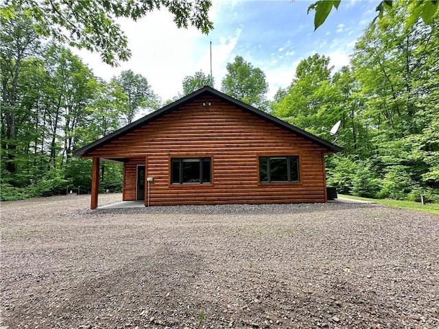 4686 W Butler Rd, Winter, WI 54896 - view of property exterior featuring faux log siding and driveway