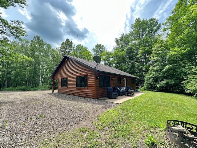 4686 W Butler Rd, Winter, WI 54896 - view of side of property featuring faux log siding, an outdoor hangout area, a patio, and a lawn