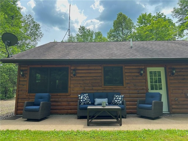 4686 W Butler Rd, Winter, WI 54896 - back of property featuring roof with shingles, a patio, an outdoor living space, and faux log siding