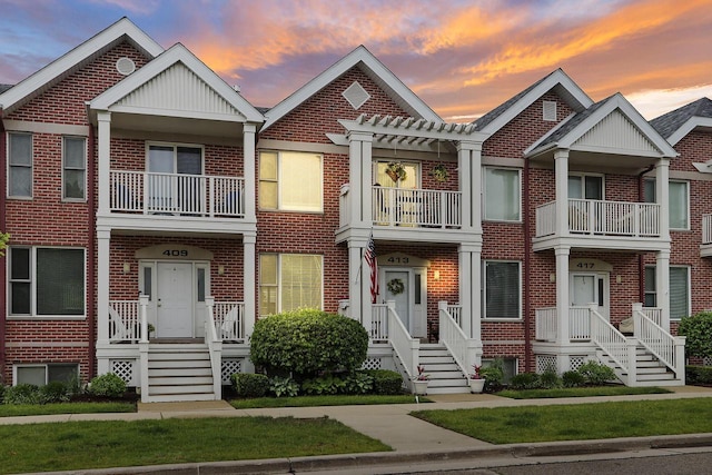 413 56th St, Kenosha, WI 53140 - view of front facade featuring brick siding, a pergola, and a balcony