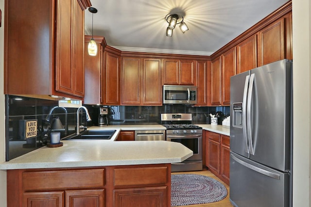413 56th St, Kenosha, WI 53140 - kitchen featuring appliances with stainless steel finishes, a peninsula, light countertops, tasteful backsplash, and decorative light fixtures