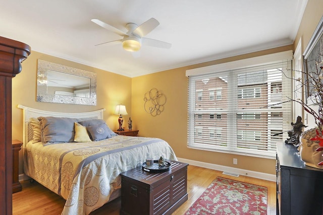 413 56th St, Kenosha, WI 53140 - bedroom with light wood finished floors, ceiling fan, and crown molding