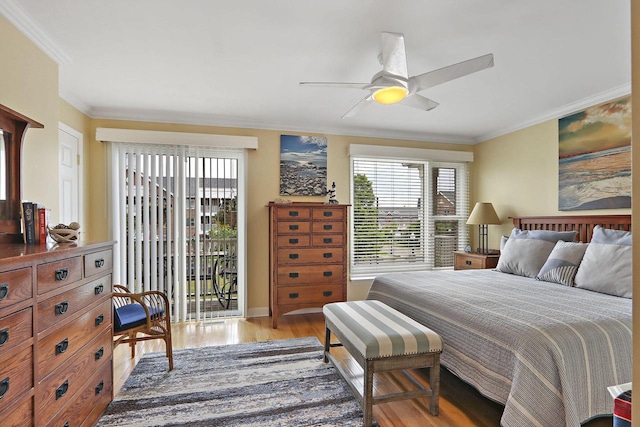 413 56th St, Kenosha, WI 53140 - bedroom featuring ornamental molding, light wood finished floors, multiple windows, access to exterior, and ceiling fan