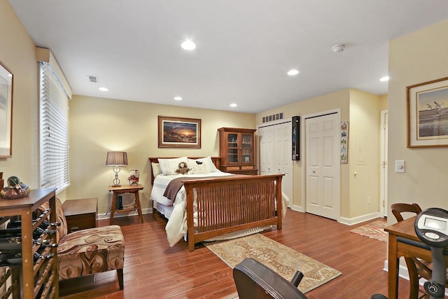 413 56th St, Kenosha, WI 53140 - bedroom with multiple closets, wood finished floors, and recessed lighting