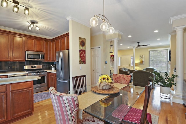 413 56th St, Kenosha, WI 53140 - kitchen with stainless steel appliances, decorative columns, light countertops, backsplash, and ornamental molding