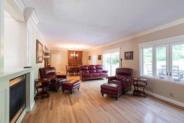 N2194 Valley Rd, La Crosse, WI 54601 - living area with a fireplace, light wood-style flooring, a chandelier, and ornamental molding