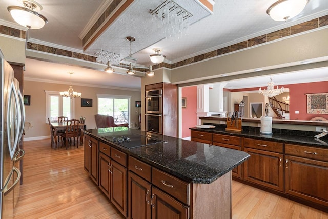 N2194 Valley Rd, La Crosse, WI 54601 - kitchen featuring appliances with stainless steel finishes, a chandelier, a kitchen island, crown molding, and light wood-style floors