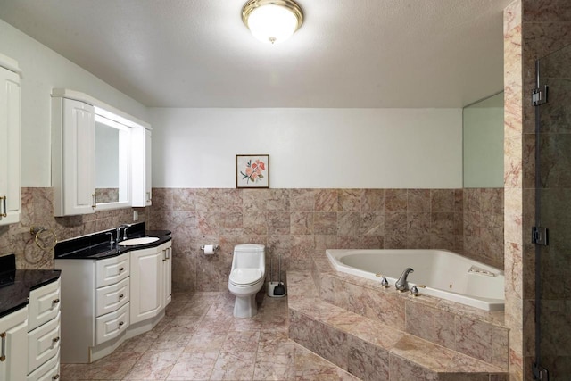 N2194 Valley Rd, La Crosse, WI 54601 - bathroom featuring vanity, a whirlpool tub, a stall shower, tile walls, and a wainscoted wall