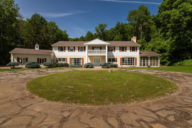 N2194 Valley Rd, La Crosse, WI 54601 - greek revival house featuring a balcony, curved driveway, a chimney, and a front lawn