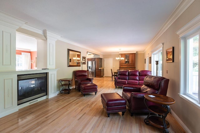 N2194 Valley Rd, La Crosse, WI 54601 - living area with a chandelier, light wood-style flooring, a glass covered fireplace, and crown molding