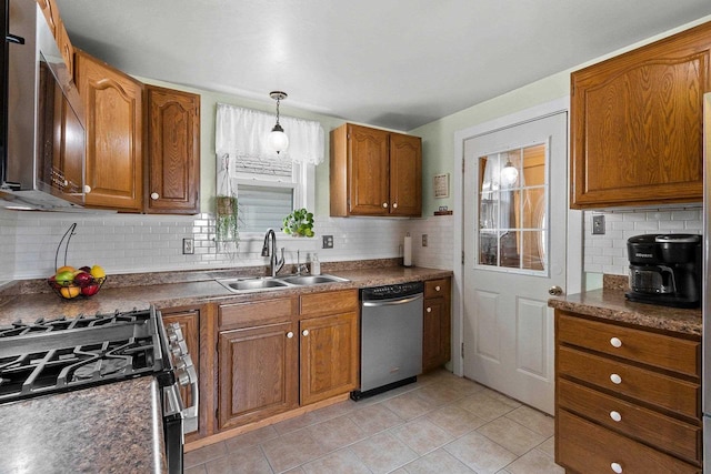931 Carney Blvd, Marinette, WI 54143 - kitchen featuring stainless steel appliances, backsplash, brown cabinets, and dark countertops