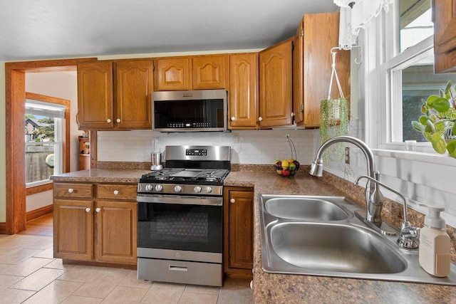 931 Carney Blvd, Marinette, WI 54143 - kitchen with stainless steel appliances, decorative backsplash, and brown cabinets