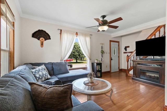 931 Carney Blvd, Marinette, WI 54143 - living room with ceiling fan, ornamental molding, light wood-style flooring, and stairs